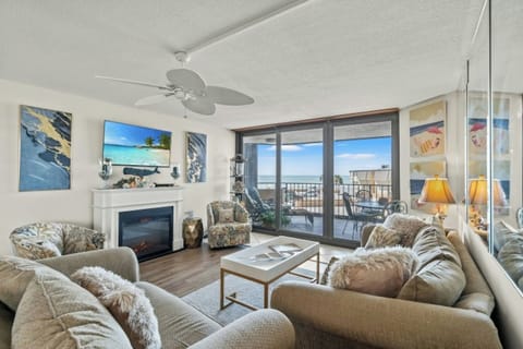 Relax in this spacious living room with a view of the ocean.