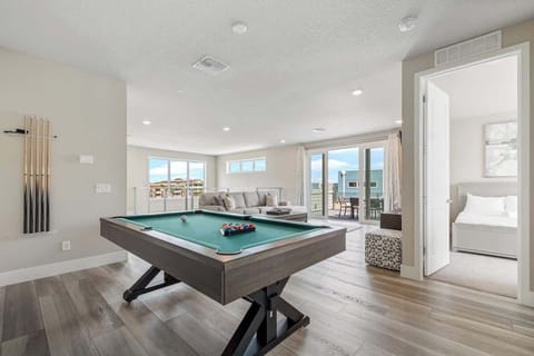 Bright, cozy living room with pool table, stunning city views, and outdoor dining. Perfect for relaxing, entertaining, and long stays. Book now for comfort, style, and a home away from home!