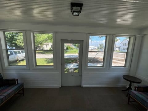 Enter through the enclosed front porch!