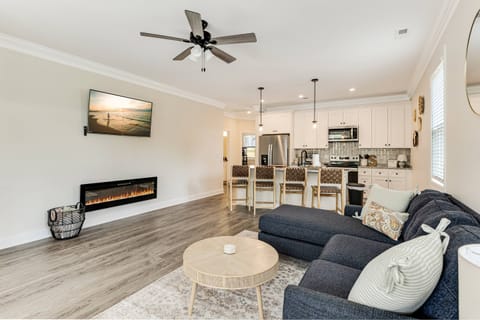 Open living room and kitchen with large smart tv