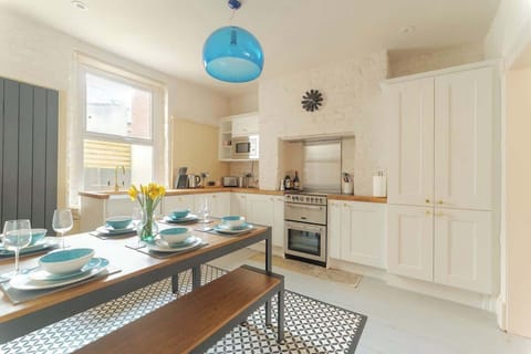 Light filled kitchen and dining. With kettle, toaster, cafetiere, pans, roasting dishes, knives, utensils, cups, glasses, crockery and cutlery. As well as picnic equipment and a flask.