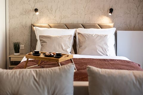 Cozy bedroom with designer wallpaper and hotel-style bed, perfect for a romantic stay in central Bydgoszcz, near Opera Nova and Mill Island.