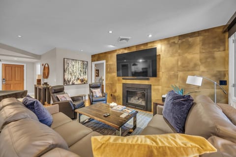 Living room: 75" Smart TV, gas fireplace, Sonos sound system, pool table, patio access, central heating and A/C