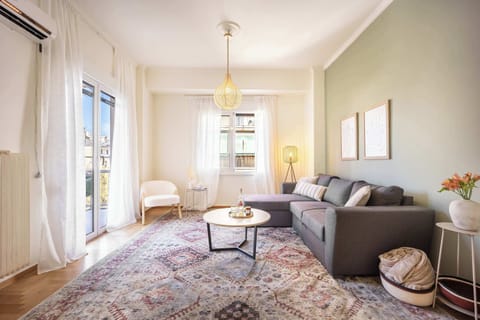 Sun-filled living room with soft textures, creating a calm retreat in central Athens.
