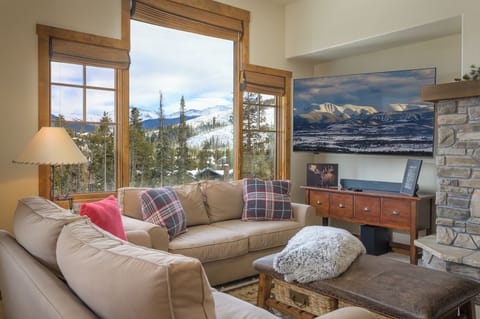 Panoramic mountain scenery from cozy living room with fireplace   - Big screen TV and warm décor make this space perfect for relaxing nights