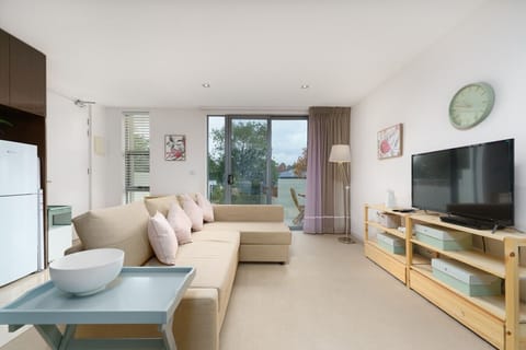 A warm and functional lounge area designed for comfort, with a large window bringing in plenty of natural light.