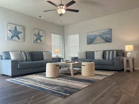 Open spacious Coastal theme living room with ample seating for a quiet night in