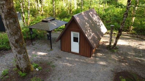 A little rustic A-frame cabin with two cots for your comfort