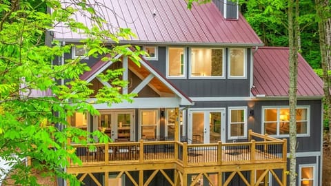 Modern cabin retreat with hot tub and wraparound decks in the forest