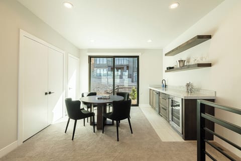 3rd level family room with a game table and  wet bar