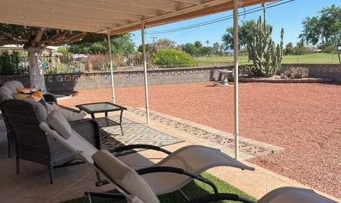 Golf course views!  Outdoor patio has roll down sun shades.