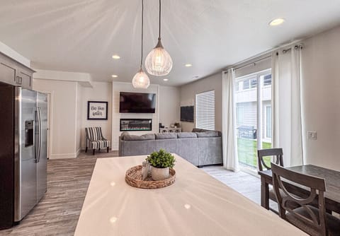 Bright open-concept living with cozy fireplace, plush seating, and seamless indoor-outdoor flow.