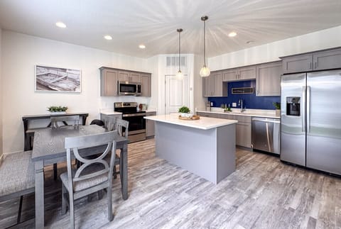 Modern kitchen with quartz countertops, stainless steel appliances, and cozy dining space for family gatherings.