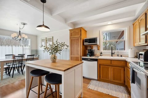 A sunny, fully equipped kitchen, featuring both a standard coffee maker and Keurig, dishwasher, microwave, toaster, and more-perfect for everything from morning pancakes to holiday dinners.