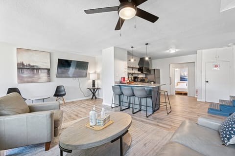 Gather for meals at the round dining table by large picture windows that frame the quiet neighborhood and let in tons of natural light.