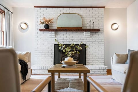 Cozy living room with warm minimalist decor and a non-functional fireplace.