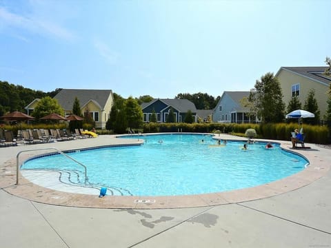 Large community pool with crystal-clear water and ample space for swimming and soaking up the sun.