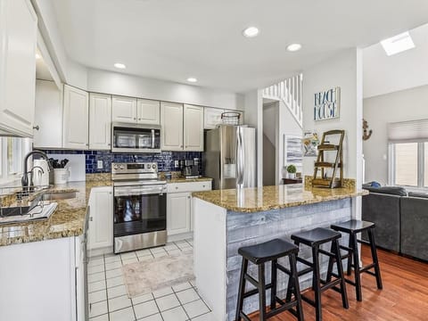 Open-concept kitchen with bar seating, ideal for casual dining or enjoying a morning cup of coffee.