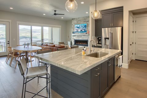 Bright kitchen and dining space with large island and sliding doors to the patio.