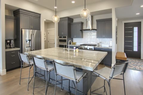 Modern kitchen with oversized island, sleek cabinetry, and pendant lighting - perfect for entertaining.
