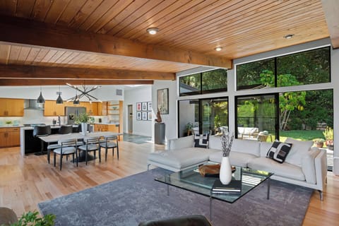 Main living area has an indoor - outdoor feel opening up to the front patio and backyard.