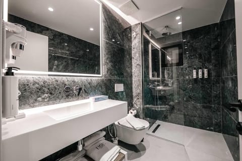 Suite, Balcony, City View | Bathroom | Shower, slippers, bidet, towels