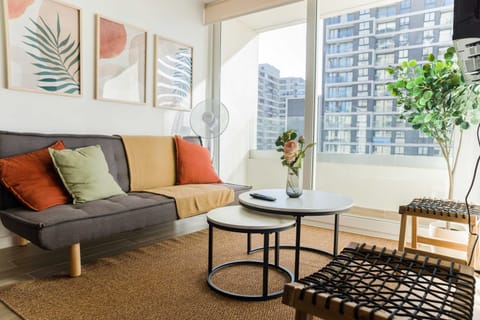 Bright and stylish living room with city views, perfect for relaxation and enjoying the urban landscape.