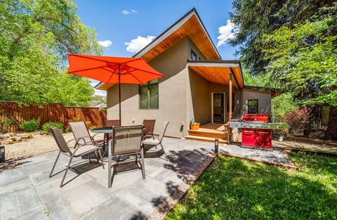 The backyard is charming and intimate, perfect for sharing meals and lounging.