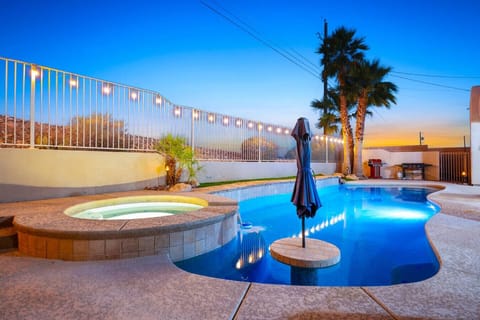 Unwind in your private oasis featuring a sparkling pool and hot tub.