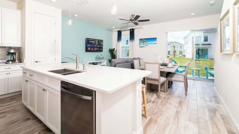 The gleaming countertop offers additional seating for 4