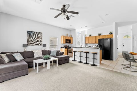 Cozy and spacious living area with TV and patio access