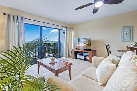 Beautiful, bright living room with a direct ocean view and warm natural light all around.