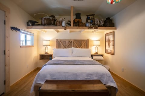 Rustic queen bed with warm lighting.