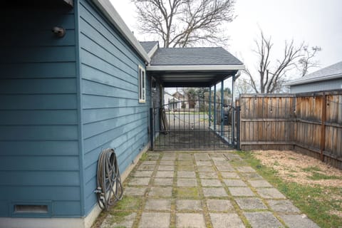 Gated side driveway with paved walkway.