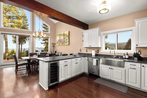 Enjoy an open-concept kitchen and dining area with lake views, high-end finishes, and plenty of space to cook, gather, and entertain.