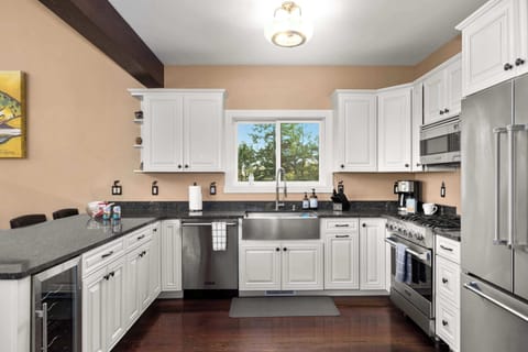 Designed for both function and beauty, this chef’s kitchen includes top-tier appliances, mountain views, and a seamless connection to the main living space.