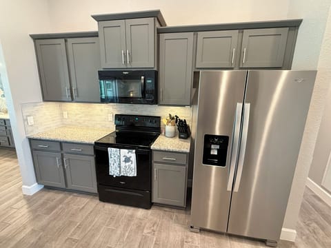 Full size fridge & essential utensils for all of your home cooking needs 