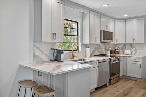 Beautiful new kitchen with quartz counters and stainless appliances