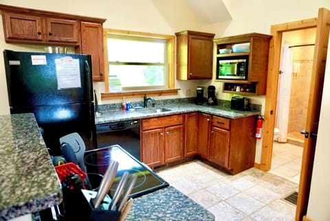 Happy cook! This charming kitchen is perfect for whipping up meals during your stay.