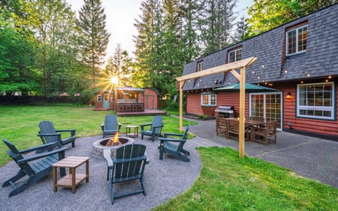 Spacious backyard with fire pit, BBQ grill, outdoor dining, and private hot tub