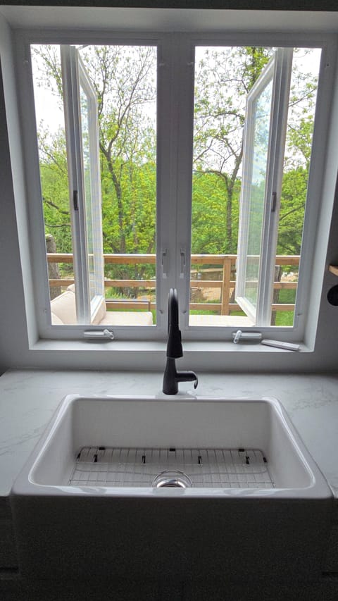 Open the kitchen window doors and bring the  views & sound of nature indoors. 