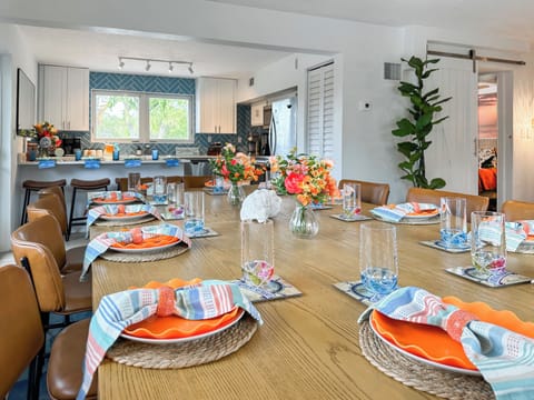 The large dining table seats 12 people with 2 on each end.