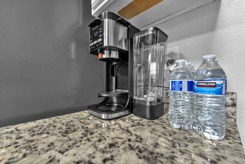 Coffee station ready — Ninja brewer + complimentary bottled water.