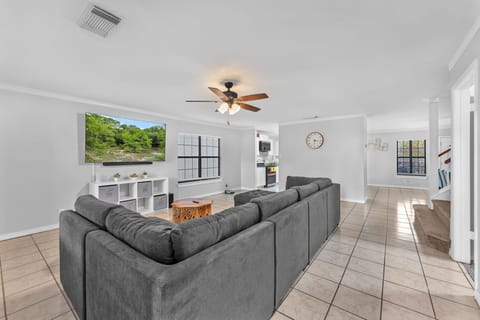 Spacious living room with big sectional and 70” TV for relaxing