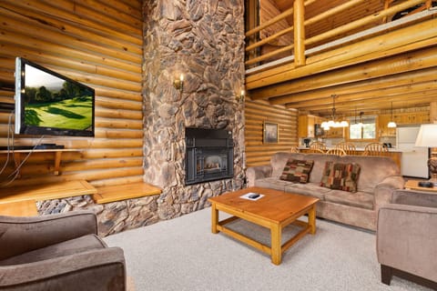 Relaxing nook with a glowing stone fireplace and plush cabin décor.
