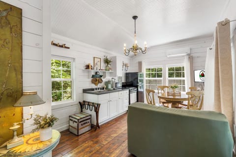 Studio-Style Floor Plan includes a Galley Kitchen, Dining Table, Twin Fold Out Loveseat, Queen Bed