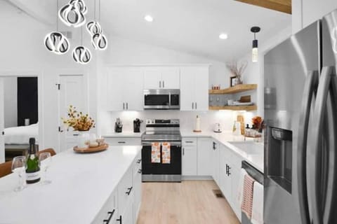 Cook in style w/ stainless appliances, Keurig, island seating & open shelving.