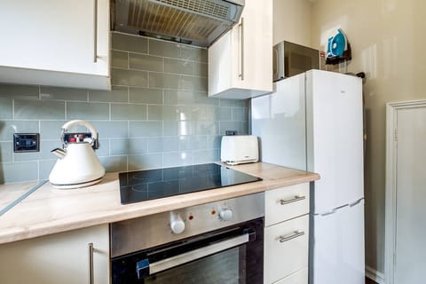 A fully equipped kitchen stocked with all the essentials you need to prepare and enjoy a home-cooked meal during your stay.