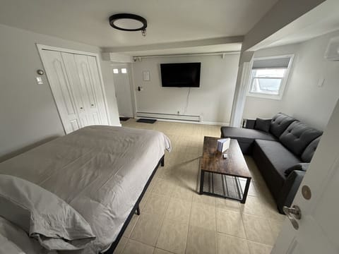 Rest easy in our cozy guest room, featuring a Queen-sized bed and dedicated bedside charging stations for all your devices.