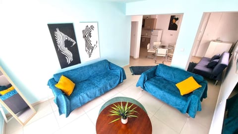 Living area, sofa, small table, mirror